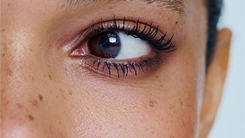 Close-up of a woman with brown eyes.