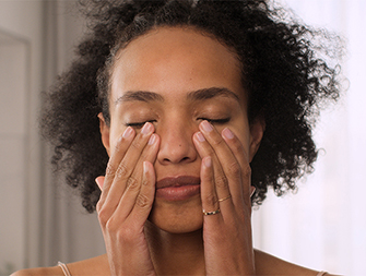 woman touching the area around her eyes